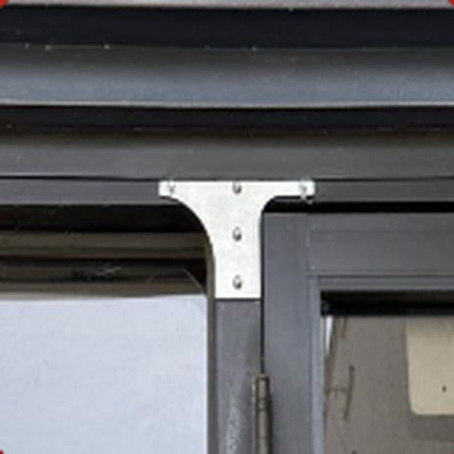 A metal bracket mounted on a door frame